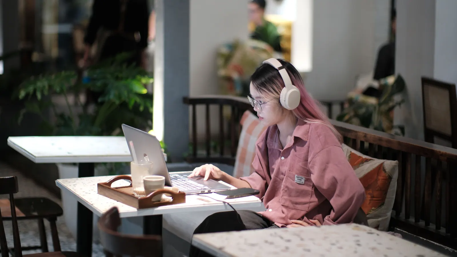 Someone working on a laptop in a cafe