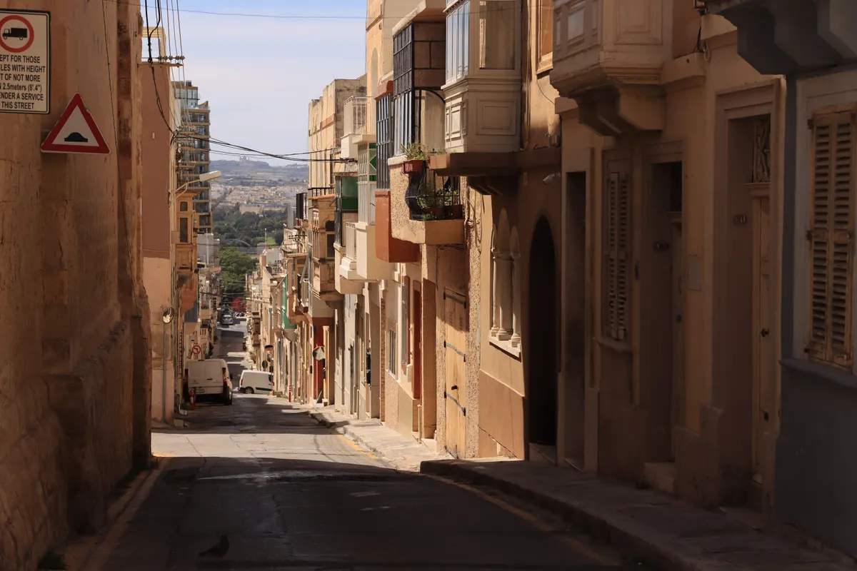 A narrow Maltese street with enclosed balconies